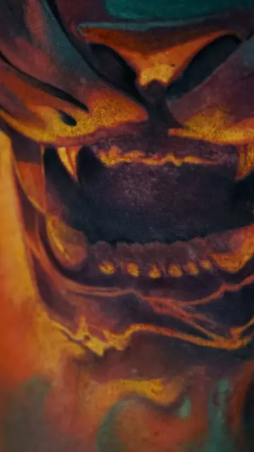 colour realism demon mask tattoo on leg