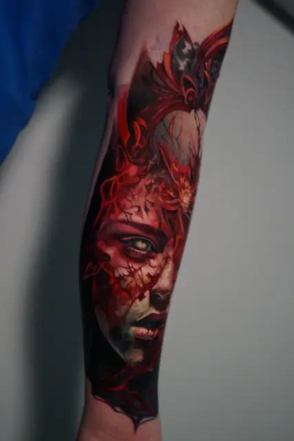 colour realism demonic woman face tattoo on forearm