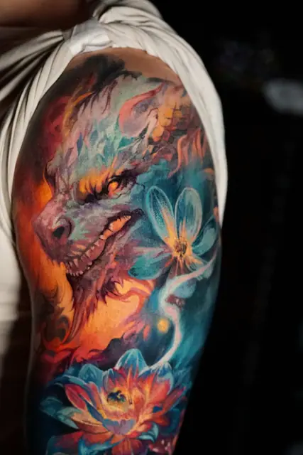 colour realism dragon and lotus flower tattoo on upper arm