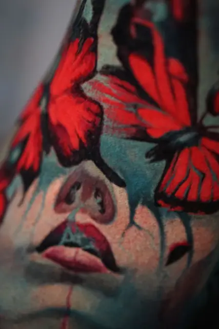 colour realism face and butterfly tattoo on leg