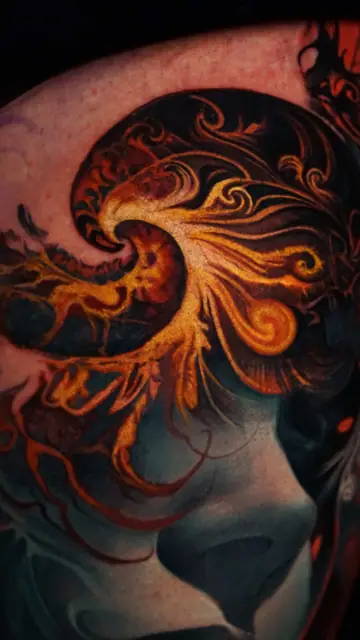 colour realism fantasy female tattoo with golden swirls on arm