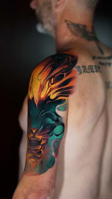 colour realism fiery monster head tattoo on arm shoulder sleeve