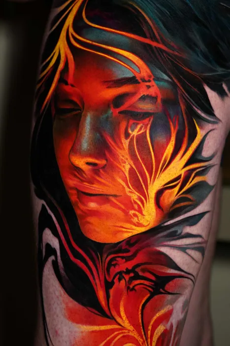 colour realism fiery woman's face tattoo on upper leg