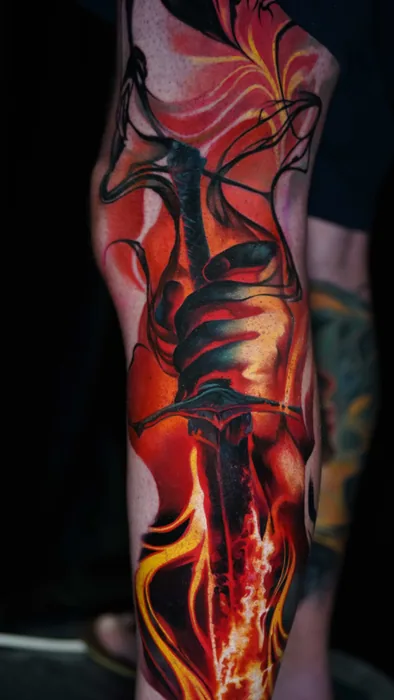 colour realism flowing flame tattoo wrapping the shin