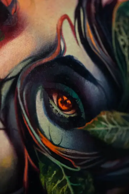 colour realism glowing eye tattoo with leaves close up