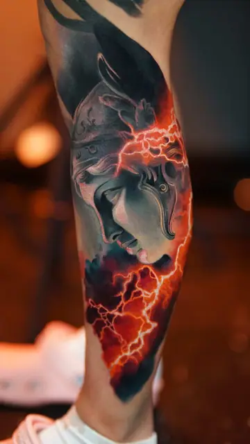 colour realism goddess with lightning tattoo on lower leg