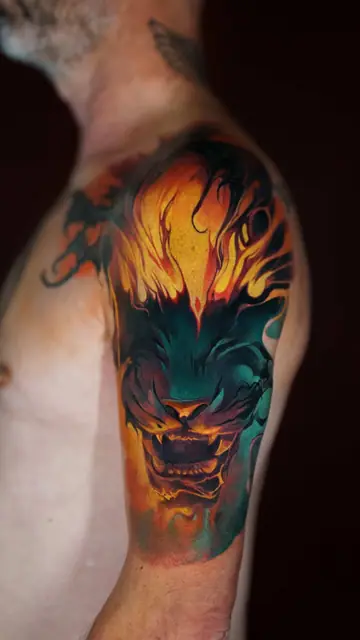 colour realism lion tattoo on shoulder and upper arm