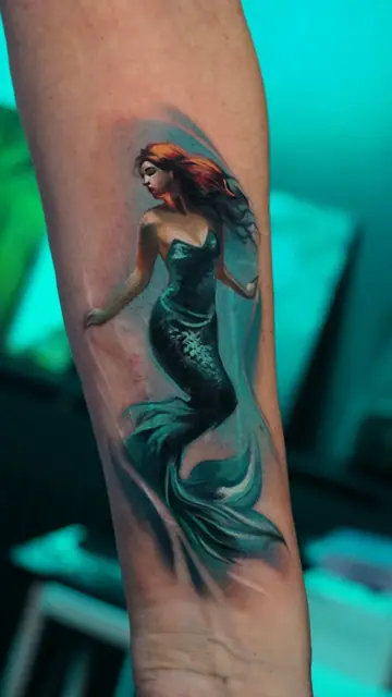 colour realism mermaid tattoo on forearm