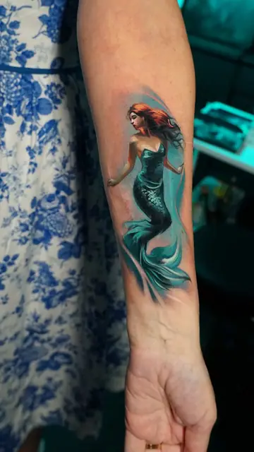 colour realism mermaid tattoo on forearm