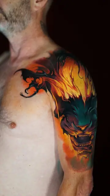 colour realism monster/lion face with fire tattoo on shoulder and upper arm