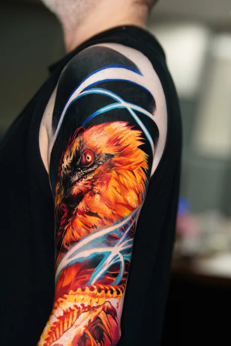 colour realism phoenix head tattoo on upper arm and shoulder