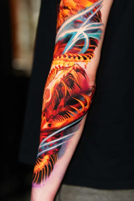 colour realism phoenix sleeve tattoo seen from the forearm