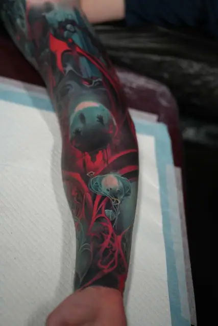 colour realism pig head, scythe, jellyfish tattoo on full arm