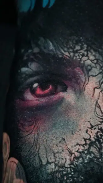 colour realism red eye demon tattoo on arm