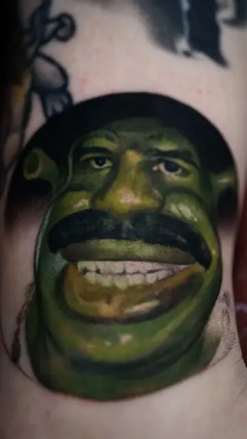 colour realism shrek with mustache tattoo on leg