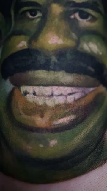 colour realism shrek tattoo with mustache, close up on skin