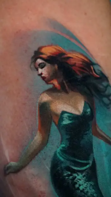 colour realism siren tattoo on upper arm