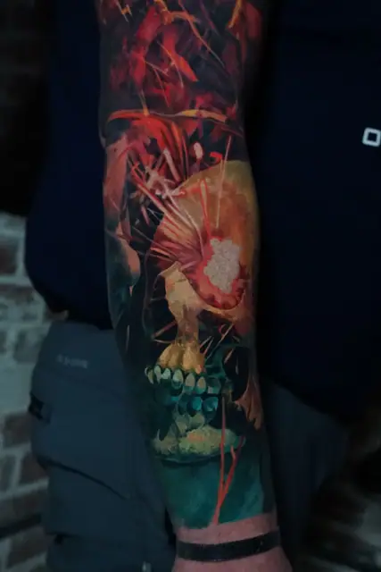 colour realism skull and foliage tattoo on forearm