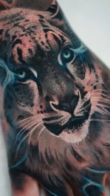 colour realism tiger face tattoo on hand