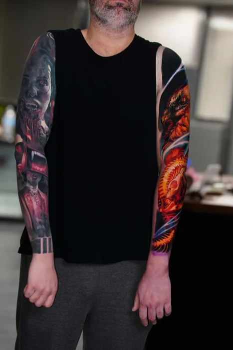 full length view of two colour realism sleeve tattoos
