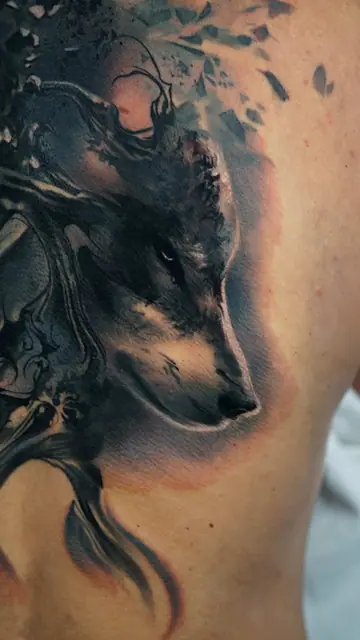 colour realism wolf head tattoo on upper back with abstract elements