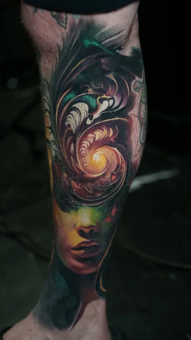 colour realism woman's face with fractal spiral tattoo on lower leg