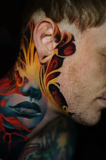 colour realism woman's face and abstract tattoo on neck and side of face