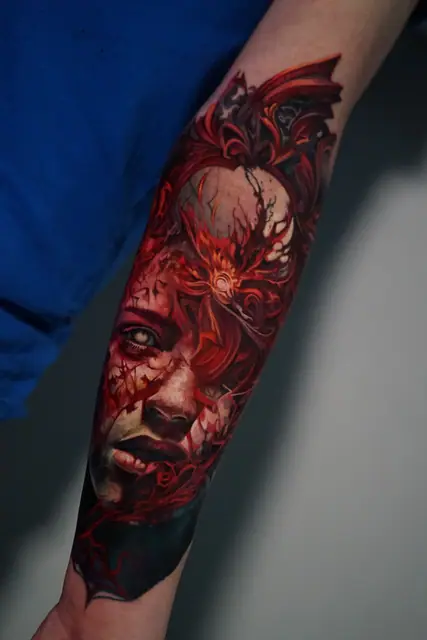 colour realism woman's face tattoo in red light on inner forearm