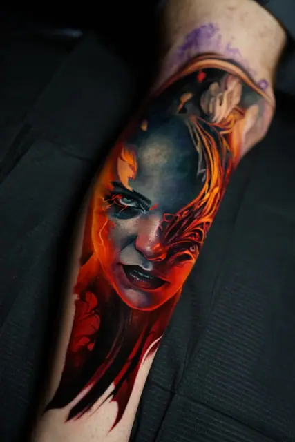 colour realism woman's face tattoo on leg