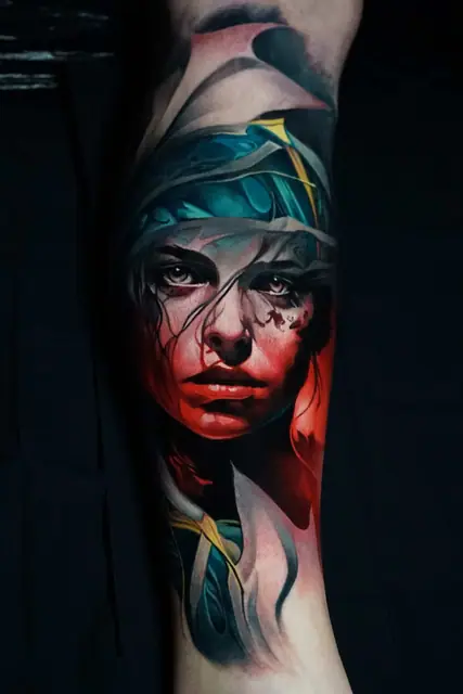 colour realism woman's face tattoo on leg