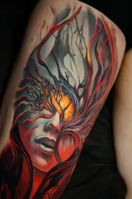 colour realism woman's face and tree tattoo on upper arm/thigh