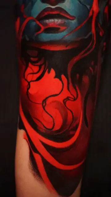 colour realism woman’s face and abstract red design on arm