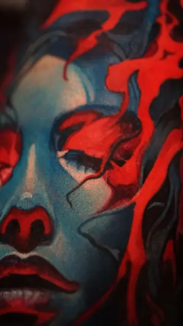 colour realism woman’s face with red elements tattoo
