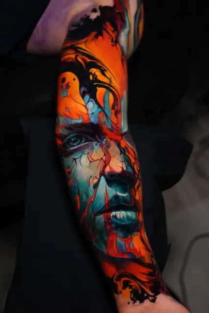 colour surreal abstract face tattoo on inner arm panel