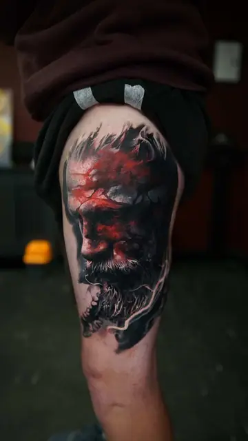 dark colour realism man's face with red on upper thigh