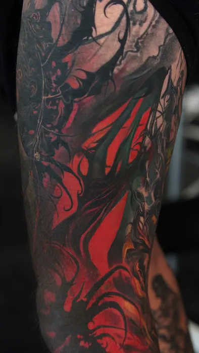 close-up detail of dark red and black abstract leg tattoo