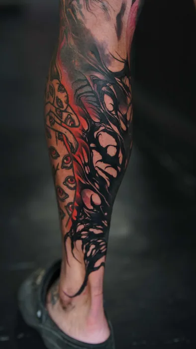 dark red and black biomechanical style leg sleeve tattoo