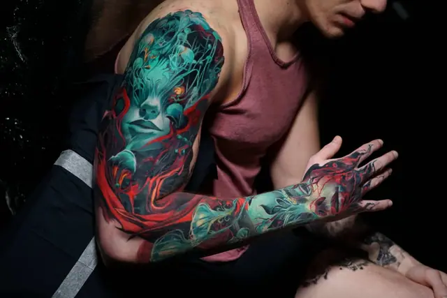 vibrant colour fantasy figure tattoo sleeve and hand